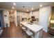 Well-equipped kitchen with a center island, stainless steel appliances, and white cabinets at 359 Courtfield Way, Castle Pines, CO 80108