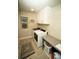 Well-lit laundry room with modern washer/dryer, storage cabinets, and shelving at 359 Courtfield Way, Castle Pines, CO 80108