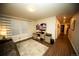 Bright living room with wood floors, large window, and desk workspace at 359 Courtfield Way, Castle Pines, CO 80108