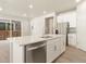 Modern kitchen island with quartz countertop and stainless steel sink at 229 Mayfly Ln, Berthoud, CO 80513