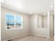 Bright living room with large window and wood-look flooring at 229 Mayfly Ln, Berthoud, CO 80513