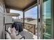 Relaxing covered balcony with seating and grill, perfect for outdoor entertaining and enjoying neighborhood views at 21436 E Stanford Ave, Aurora, CO 80015