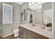 Bright bathroom featuring a spacious vanity with solid surface countertops, and a tiled shower at 21436 E Stanford Ave, Aurora, CO 80015