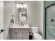 Modern bathroom featuring a vanity with dark fixtures and glass door walk-in shower at 21436 E Stanford Ave, Aurora, CO 80015