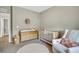 Neutral Bedroom with crib, changing table, comfortable chair, and a decorative round rug at 21436 E Stanford Ave, Aurora, CO 80015
