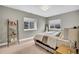 Relaxing bedroom with warm tones, comfy king bed, and natural light from two windows at 21436 E Stanford Ave, Aurora, CO 80015