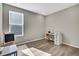 Bright bedroom featuring hardwood floors, a large window, and a dedicated desk space for work or study at 21436 E Stanford Ave, Aurora, CO 80015