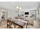 Bright dining room offers view into adjacent living room with fireplace at 21436 E Stanford Ave, Aurora, CO 80015