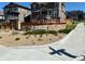 Stone entrance to the Alder community, with lush green plants and well-maintained landscaping at 21436 E Stanford Ave, Aurora, CO 80015