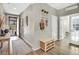 Welcoming entryway with wood floors, plants, shelf and decor creating a warm reception at 21436 E Stanford Ave, Aurora, CO 80015