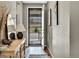 Inviting entryway with wood floors, neutral walls, and a view through the front door at 21436 E Stanford Ave, Aurora, CO 80015
