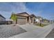 Lovely single-story home with two-car garage, landscaped with stone and a tree-lined yard at 21436 E Stanford Ave, Aurora, CO 80015