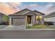 Charming single-Gathering home with a two-car garage and professionally landscaped front yard at dusk at 21436 E Stanford Ave, Aurora, CO 80015