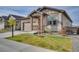 Well-maintained home showcasing the attached two-car garage, lush lawn and an attractive facade at 21436 E Stanford Ave, Aurora, CO 80015