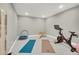 Bright exercise room with a Peloton bike, yoga mats, and mounted training equipment at 21436 E Stanford Ave, Aurora, CO 80015