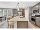 Spacious kitchen featuring a large island with seating, modern appliances, and stylish finishes at 21436 E Stanford Ave, Aurora, CO 80015