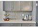 Stylish kitchen counter with decorative backsplash, modern grey cabinets, and functional storage solutions at 21436 E Stanford Ave, Aurora, CO 80015