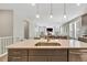 Well-lit kitchen island, stainless sink, and open layout, seamlessly connecting to the dining and living spaces at 21436 E Stanford Ave, Aurora, CO 80015