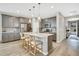 Well-appointed kitchen with gray cabinetry, a large island, pendant lighting, and stainless-steel appliances at 21436 E Stanford Ave, Aurora, CO 80015