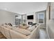 Bright living room features fireplace, large sectional, and abundant natural light at 21436 E Stanford Ave, Aurora, CO 80015