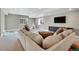 Cozy living room with a plush sectional sofa, dark console, and large windows at 21436 E Stanford Ave, Aurora, CO 80015