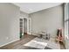 Versatile room featuring an easel, small table with chairs, wood floors, and French doors at 21436 E Stanford Ave, Aurora, CO 80015