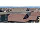 High-angle view showcasing the diverse rooftops of a residential neighborhood against a distant mountain backdrop at 21436 E Stanford Ave, Aurora, CO 80015