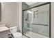 Modern bathroom with a glass enclosed shower, tiled walls, and matte black shower head at 21436 E Stanford Ave, Aurora, CO 80015