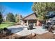 Backyard featuring a patio, outdoor grill, dining table, garden beds and mature trees at 8004 S Oneida Ct, Centennial, CO 80112