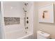 Bathroom with a shower-bath combination, white subway tile, and modern fixtures at 8004 S Oneida Ct, Centennial, CO 80112