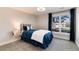 Bright bedroom features a large window, neutral walls, and carpeted floor at 8004 S Oneida Ct, Centennial, CO 80112