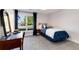 This bedroom features a neutral color scheme, a large window, and carpeted floors at 8004 S Oneida Ct, Centennial, CO 80112