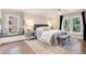 Inviting bedroom with natural light, cozy bench seat, and hardwood floors at 8004 S Oneida Ct, Centennial, CO 80112