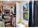 This organized closet offers a variety of shelving and hanging options along with a window for light at 8004 S Oneida Ct, Centennial, CO 80112