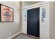 Stylish entryway with a dark blue door, white trim, and eye-catching artwork at 8004 S Oneida Ct, Centennial, CO 80112
