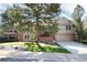 Beautiful home exterior featuring a well-maintained lawn, mature trees, and attached garage at 8004 S Oneida Ct, Centennial, CO 80112