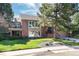 Attractive two-story home with brick and siding, a well-maintained lawn, and mature trees at 8004 S Oneida Ct, Centennial, CO 80112
