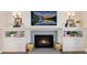 Cozy fireplace with detailed mantel, blue tile surround, and built-in cabinets at 8004 S Oneida Ct, Centennial, CO 80112