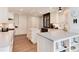 Modern kitchen with white cabinetry, dual islands, stainless steel appliances, and wood floors at 8004 S Oneida Ct, Centennial, CO 80112