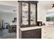 Kitchen with decorative dishware cabinet, white countertops, and dining area in the background at 8004 S Oneida Ct, Centennial, CO 80112