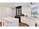 Well-lit kitchen featuring white cabinetry, a central island, and modern appliances at 8004 S Oneida Ct, Centennial, CO 80112