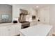 Bright kitchen features white cabinets, stainless steel appliances, and a large center island at 8004 S Oneida Ct, Centennial, CO 80112