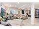 Spacious living room with a large sectional sofa, modern decor, and a view to the office at 8004 S Oneida Ct, Centennial, CO 80112
