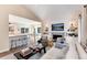 Open-concept living room with eat-in kitchen, fireplace, and comfortable seating at 8004 S Oneida Ct, Centennial, CO 80112