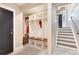 Mudroom with coat hooks, bench, cubbies, and views of the stairs and front door at 8004 S Oneida Ct, Centennial, CO 80112
