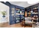 Study with built-in bookshelves, a comfortable chair, and stylish decor at 8004 S Oneida Ct, Centennial, CO 80112