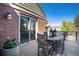 Cozy patio featuring a wooden table and chairs, with access via sliding glass door at 8004 S Oneida Ct, Centennial, CO 80112