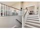 Elegant staircase with wood and white accents, leading to a bright living area at 8004 S Oneida Ct, Centennial, CO 80112