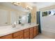 Bathroom with double sinks, shower, and bathtub at 1402 Sterling Hill Ct, Castle Rock, CO 80104