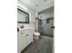 Modern bathroom featuring a glass-enclosed shower and white vanity at 13781 E Lehigh Ave # E, Aurora, CO 80014